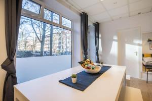 a kitchen with a bowl of food on a counter at Spacious Two BR Close To Stadtpark and Street Parking in Hamburg