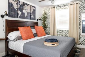 a bedroom with a bed with orange pillows at Step Free Entrance-Wolfe Cottage at Wrenwood Ranch, King Bed in Johnson City