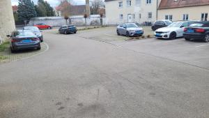 a parking lot with several cars parked in it at Hotel Gasthof Specht in Aichach