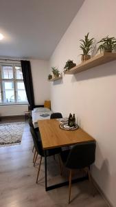 a dining room with a table and some plants at Apartmány na Trojce in Žatec