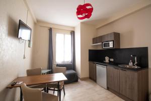 Hôtel Chez MiMi في بار سور سين: غرفة معيشة مع طاولة طعام ومطبخ