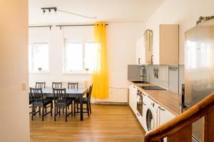 a kitchen and dining room with a table and chairs at Three Bedroom plus big kitchen plus SelfCheckIn plus Street Parking in Berlin