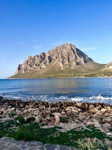 a mountain on the shore of a body of water at B&B al Centro del Borgo in Custonaci