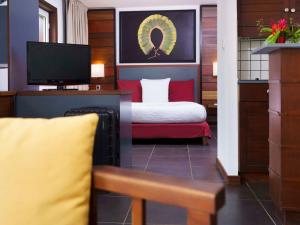 Habitación de hotel con cama y TV en Hotel Mercure Kourou Ariatel, en Kourou
