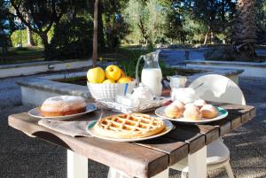 a picnic table with waffles and fruit and milk at Tenuta Primaterra in Melendugno
