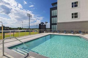 a swimming pool in front of a building at Hyatt Place Greensboro Downtown in Greensboro