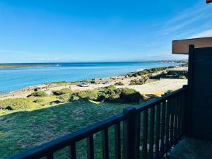 a view of the ocean from a balcony at Residence Hotel La Pelosetta in Stintino
