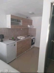 a small kitchen with a sink and a stove at Elvi Apartment 4 in Rakhónion