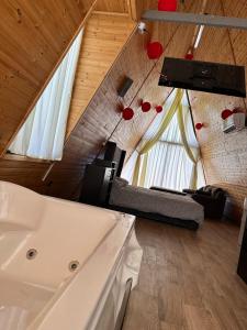 a bathroom with a sink and a couch in a room at The royal cottage Amman in Al Qasţal