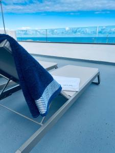 a bench on a boat with a towel on it at Bella Home in Garachico