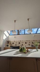 eine Küche mit zwei Leuchten und einer Arbeitsplatte in der Unterkunft Villa Brunelle, Vue bords de Rance in Le Minihic-sur-Rance