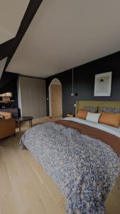 een slaapkamer met een groot bed in een kamer bij Villa Brunelle, Vue bords de Rance in Le Minihic-sur-Rance