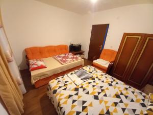a room with two beds in a room at Etno House Mira in Virpazar