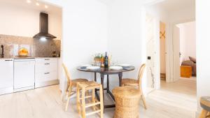 a kitchen with a table and chairs in a room at CORAL 14 in Llafranc