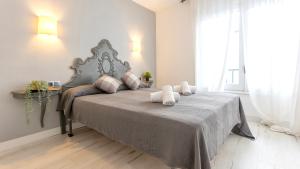 a bedroom with a large bed with two towels on it at CORAL 14 in Llafranc