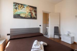 1 dormitorio con 1 cama y una pintura en la pared en Il Cinquecento, en La Spezia
