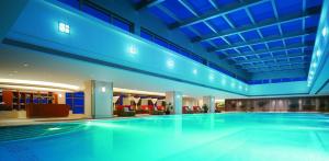 a large swimming pool in a building with blue lighting at Shangri-La Guangzhou-3 minutes by walking to Canton Fair Complex in Guangzhou