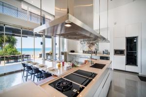 a kitchen with a view of the ocean at villa Casa De Playa in Amphoe Thalang