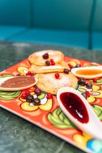 a plate of food with pancakes and fruit on it at HOTEL 1+1 di C.Costabile & f.lli in Pontecagnano