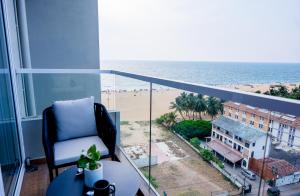 a room with a balcony with a view of a beach at Sea Breeze Heaven Residencies By Cocotech in Negombo
