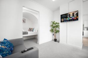 a living room with a couch and a tv on a wall at Perry Barr -1 Bed Canal Side Apartment - Top Rated - Netflix - Wifi - Parking - 1PB in Birmingham