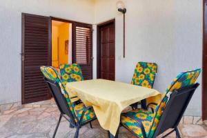 a table and chairs sitting on a patio at Apartments Davorka in Banjole