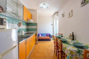 a kitchen with a table with chairs and a counter top at Apartments Davor in Banjole +44 photos