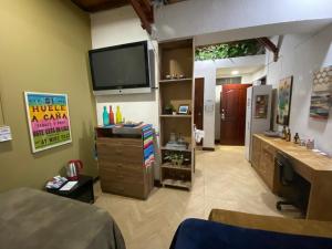 a living room with a tv on the wall at Apartarstudio muy bien ubicado, cercano a todo!! in Cali