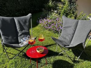 two chairs and a table with two glasses of wine at Lovely apartment in Ofterschwang in Ofterschwang