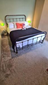 a bedroom with a bed with a black frame at Jasper's by Spires Accommodation a great base to stay for Alton Towers and corporate clientele working away from home in Stoke on Trent