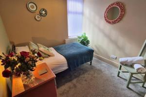 a bedroom with a bed and a table and a chair at Jasper's by Spires Accommodation a great base to stay for Alton Towers and corporate clientele working away from home in Stoke on Trent