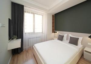 Säng eller sängar i ett rum på Sweet Home Apart-Hotel
