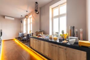 a kitchen with a counter with food on it at Pension Padre in Ostrava