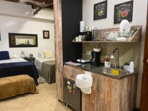 a kitchen with a sink in a room with a bed at Apartarstudio muy bien ubicado, cercano a todo!! in Cali