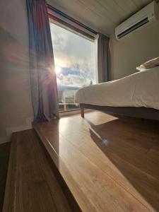 a bedroom with a bed and a large window at BoxHome Navafría in Navafría +23 photos