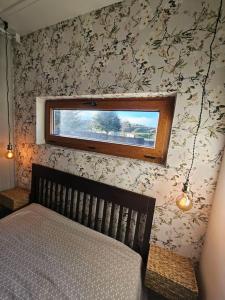 a bedroom with a wooden bed and a window at BoxHome Navafría in Navafría