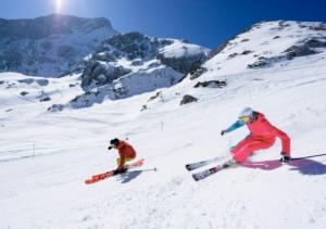 two people are skiing down a snow covered mountain at Stylish and modern - Alm-Flat-Vacation in Oberau