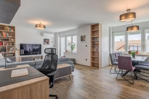 a living room with a couch and a table and chairs at Bells & Whistles, Comfortable Condo in Split