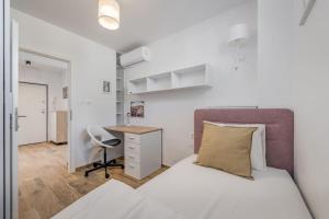 a bedroom with a bed and a desk and a chair at Bells & Whistles, Comfortable Condo in Split