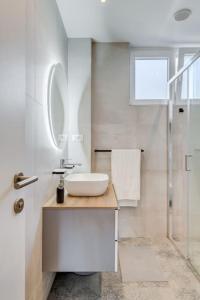 a white bathroom with a sink and a shower at Bells & Whistles, Comfortable Condo in Split +19 photos