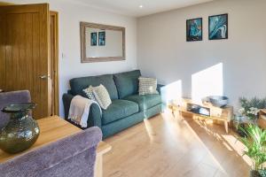 a living room with a couch and a table at Host & Stay - Willow Barn in Aldington