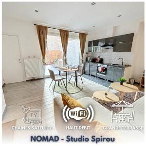 a living room with a table and chairs and a kitchen at NOMAD APARTMENTS - Henin in Charleroi