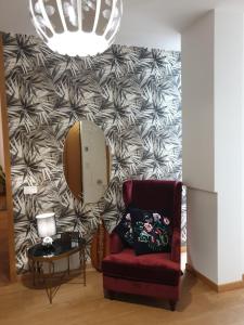 een woonkamer met een stoel en een muur bij Aparthotel Dei Mercanti in Milaan