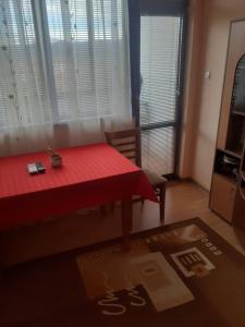 a room with a table with a red table cloth at Apartment Ceco in Troyan