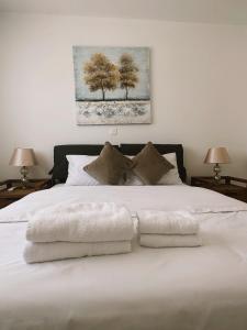 Un dormitorio con una cama blanca con toallas. en Elysia Park Ameliya 202, en Pafos
