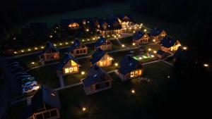 an aerial view of a house at night with lights at NoName Resort in Łapsze Niżne