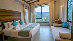 a bedroom with a large bed and a large window at Misty Villa Powered by TSC in Pussellawa