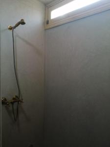 baño con cabina de ducha y ventana en Jolie Appartement, en Agadir