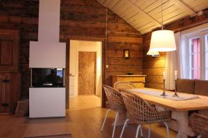 a kitchen and dining room with a table and chairs at Elisabeth-Bua in Moskenes +15 photos
