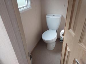 a bathroom with a white toilet in a room at A Hillside Retreat - with garden in Hastings